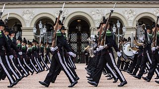 Members of the Norwegian Royal Guard parade in front of the Royal Palace in Oslo