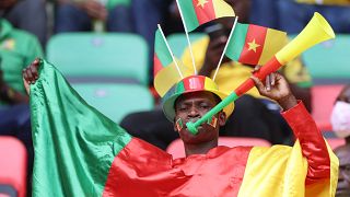 A Cameroonian football supporter cheers ahead of the opening ceremony of the Africa Cup of Nations (CAN) 2021 football tournament.