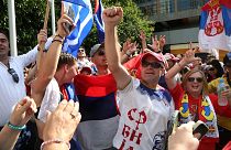 Fans of Serbia's Novak Djokovic react to news of his overturned ruling outside Federal Court ahead of the Australian Open in Melbourne, Australia, Monday, Jan. 10, 2022. 
