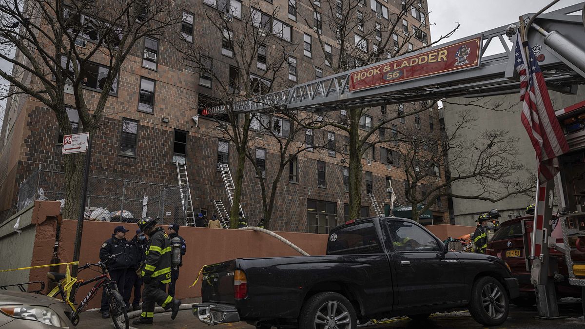 Emergency personnel work at the scene of a fatal fire at an apartment building in the Bronx, in New York.