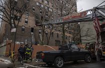 Emergency personnel work at the scene of a fatal fire at an apartment building in the Bronx, in New York.