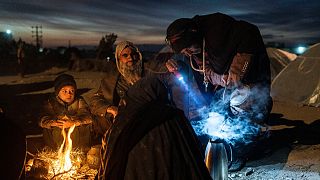 A family prepares tea outside the Directorate of Disaster office where they are camped, in Herat, Afghanistan, on Nov. 29, 2021. 