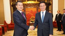 China's First Vice Premier of the State Council Han Zheng (R) and Kazakhstan's Deputy Prime Minister Alikhan Smailov (L) attend a meeting in Beijing on March 19, 2019.