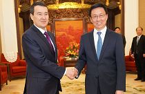China's First Vice Premier of the State Council Han Zheng (R) and Kazakhstan's Deputy Prime Minister Alikhan Smailov (L) attend a meeting in Beijing on March 19, 2019.