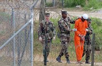 أفراد من الشرطة العسكرية في سجن غوانتانامو الأميركي بخليج كوبا يأخذون أسيرا للتحقيق