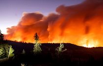 Seen in a long camera exposure, the Caldor Fire burns on Sunday, Aug. 29, 2021, in Eldorado National Forest, Calif.