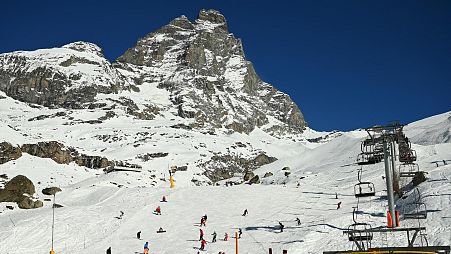 Tourists ski and rest in the sun under the Matterhorn mount (Monte Cervino) in the alpine ski resort of Breuil-Cervinia, northwestern Italy.