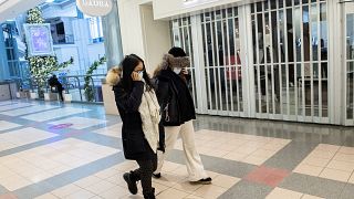 People walk by a closed store in a mall in Montreal, Sunday, Jan. 2, 2022, as the COVID-19 pandemic continues in Canada.