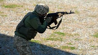 A reservist from the Ukrainian Territorial Defense Forces trains at a military training ground outside capital Kyiv, Ukraine, Saturday, Oct. 2, 2021.