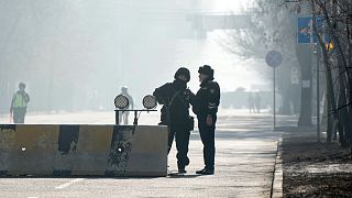 Kazakh police block the road to control the traffic in Almaty.