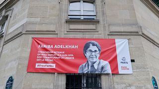 The portrait of French-Iranian academic Fariba Adelkhah, who has been detained in Iran since June 2019, is displayed on the Paris Centre town hall building.