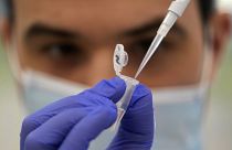 Research assistant Robert demonstrates how to prepare a sample for sequencing at the Wellcome Sanger Institute, Genome Campus, Hinxton, Cambridgeshire, England