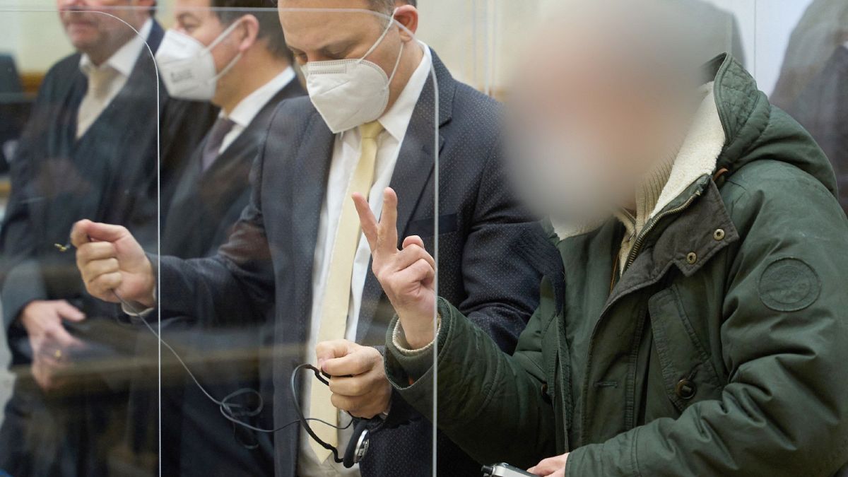 Former Syrian intelligence officer Anwar Raslan (R) gestures in the courtroom at a courthouse in Koblenz, western Germany, on January 13, 2022 on the last day of his trial 
