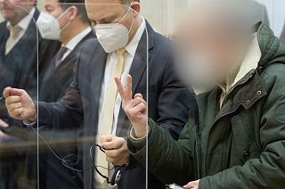 Former Syrian intelligence officer Anwar Raslan (R) gestures in the courtroom at a courthouse in Koblenz, western Germany, on January 13, 2022 on the last day of his trial