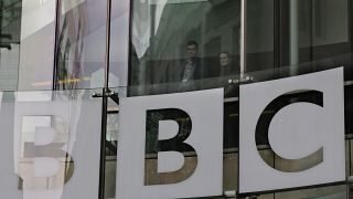 In this Thursday, March 28, 2013 file photo, people look out from inside BBC's New Broadcasting House, in central London