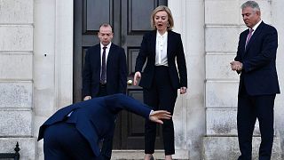 UK Foreign Secretary Liz Truss, centre, reacts as EU post-Brexit negotiator Maros Sefcovic slips on an icy step upon his arrival for a meeting at Chevening in Kent,