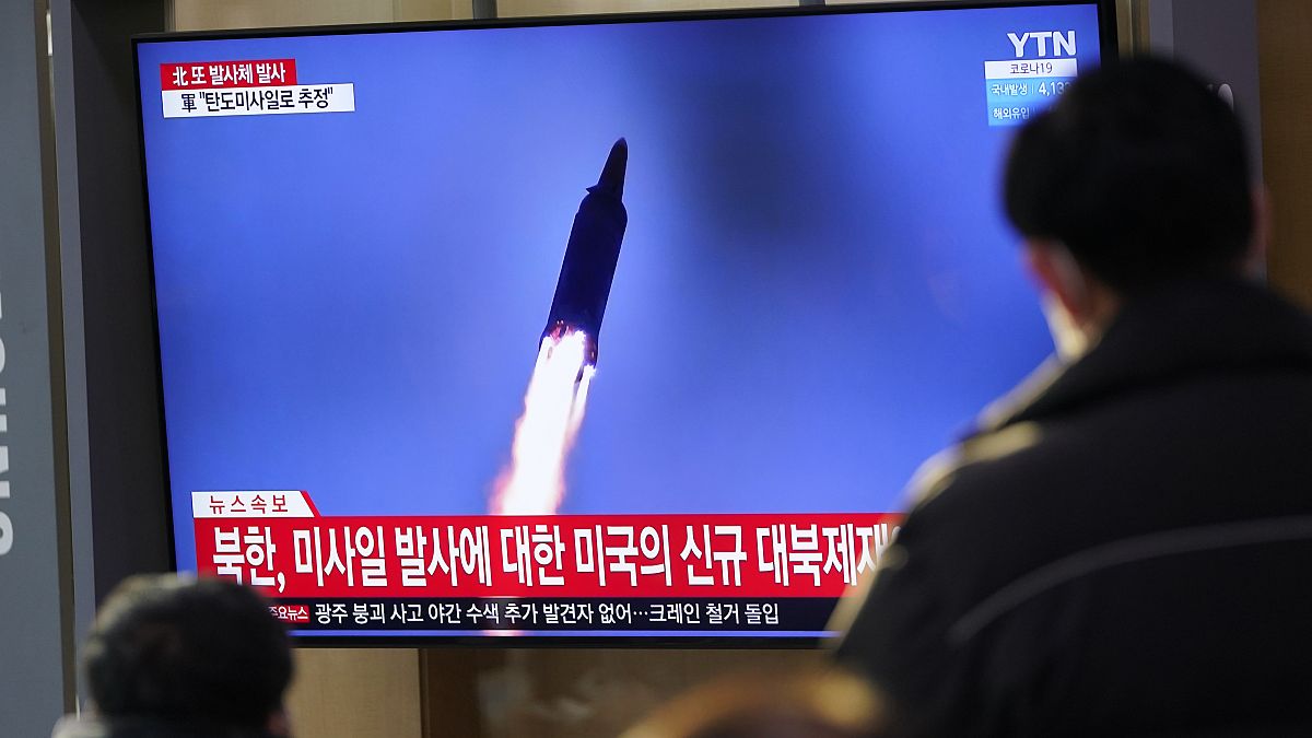 People watch a TV screen showing a news program reporting about North Korea's missile launch with a file image, at a train station in Seoul, South Korea, Jan. 14, 2022.