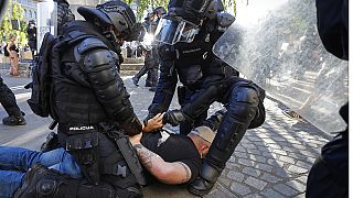 A protester is detained by anti-riot police during an anti-government demonstration in Ljubljana, Slovenia, June 2021