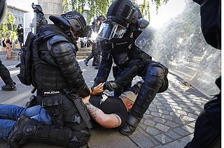 A protester is detained by anti-riot police during an anti-government demonstration in Ljubljana, Slovenia, June 2021