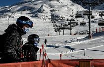 People take a ski lift wearing a mandatory mask as a preventive measure against Covid-19  at the Alpe d’Huez ski resort in France.