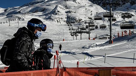 People take a ski lift wearing a mandatory mask as a preventive measure against Covid-19  at the Alpe d’Huez ski resort in France. 