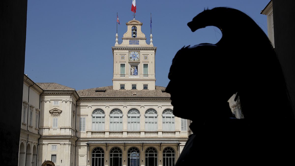 A Courassier presidential guard is silhouetted in the courtyard of Rome's Quirinale presidential palace, Thursday, Aug. 29, 2019