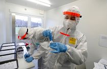 FILE- Medical workers examine the rapid antigen tests for the coronavirus in Prague, Czech Republic, Wednesday, Dec. 16, 2020.