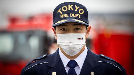 Japan's firefighters - like this member of the Tokyo fire department - are not permitted to hold second jobs