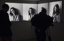 FILE- Journalist takes images of pictures of Anne Frank at the renovated Anne Frank House Museum in Amsterdam, Netherlands, Wednesday, Nov. 21, 2018.