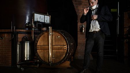 Distillery owner Eric Pinard checks the distillation process of Cognac, a white wine eau-de-vie obtained from a double distillation in a Charentais still