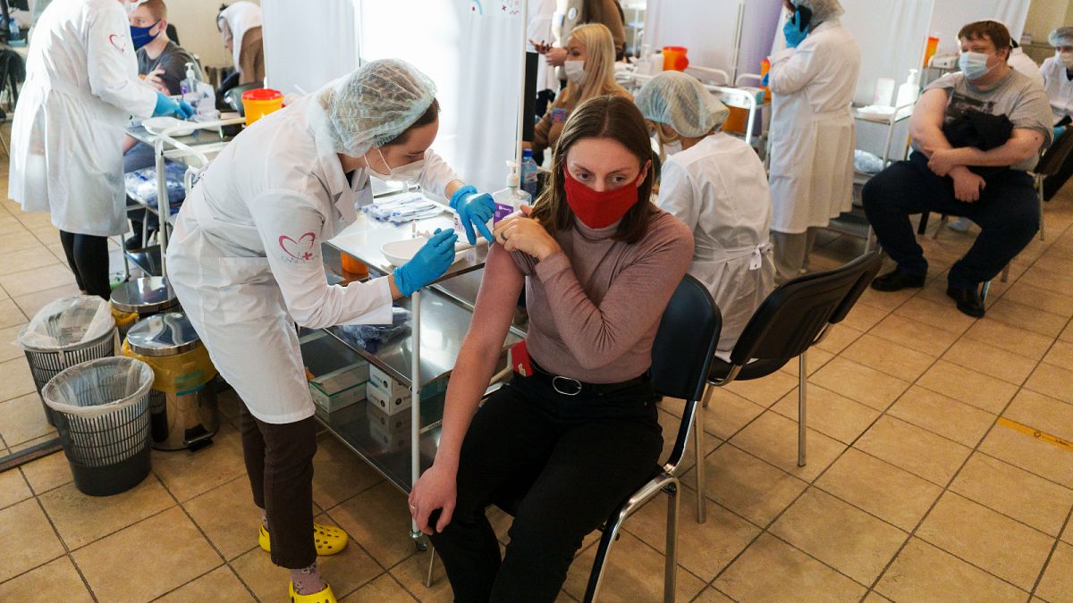 A medical worker administers a shot of Russia's Sputnik V coronavirus vaccine at a vaccination center in Moscow, Russia, Friday, Dec. 10, 2021. 