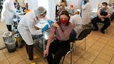 A medical worker administers a shot of Russia's Sputnik V coronavirus vaccine at a vaccination center in Moscow, Russia, Friday, Dec. 10, 2021.