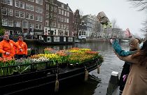 The vessel meandered through Amsterdam's waterways, handing out free bouquets to members of the public