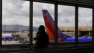 Un pasajero pasa por delante de un avión de Southwest Airlines en el aeropuerto internacional Sky Harbor de Phoenix, el 26 de marzo de 2021
