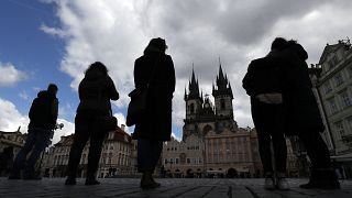 People observe a minute of silence to commemorate the anniversary of the death of the first Czech COVID-19 patient.