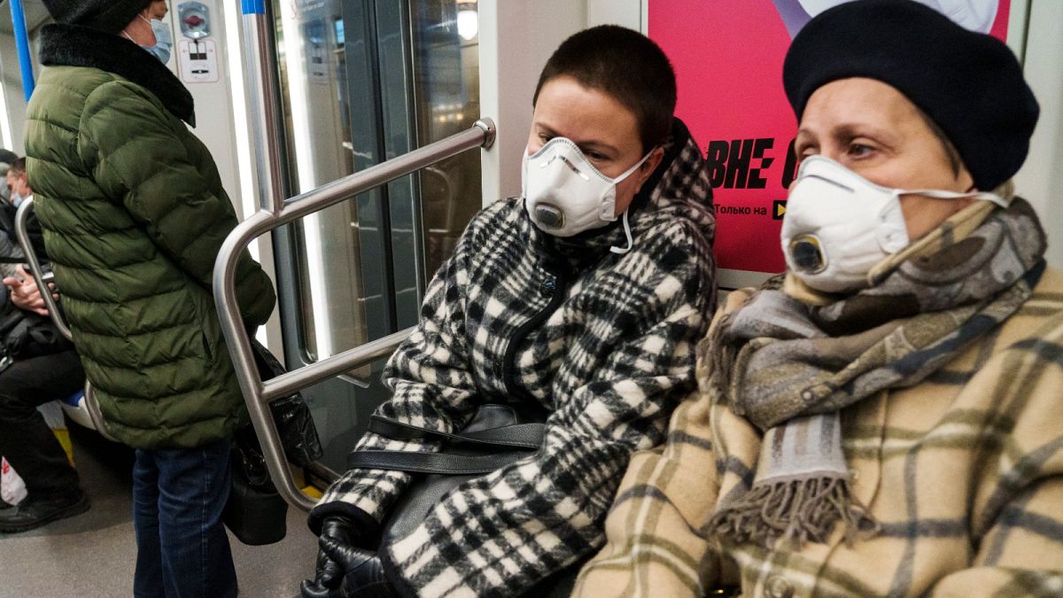 People wearing face masks travel on a metro train in Moscow, Russia, Thursday, Nov. 18, 2021.