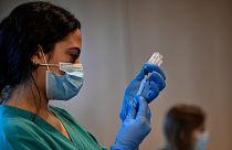 A medical staff member prepares a dose of the Moderna COVID-19 vaccine, at San Pedro Hospital in Logrono, northern Spain, Tuesday, Jan. 18. 2022.