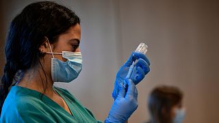 A medical staff member prepares a dose of the Moderna COVID-19 vaccine, at San Pedro Hospital in Logrono, northern Spain, Tuesday, Jan. 18. 2022. 