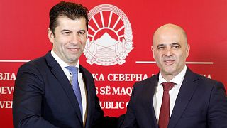 Bulgaria's Prime Minister Kiril Petkov (L) and North Macedonia's Prime Minister Dimitar Kovacevski (R) shake hands during a news conference, 18 January 2022.