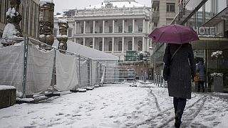 A person walks in front of the Palais Coburg in Vienna, Austria where talks on reviving the 2015 nuclear deal are proceeding behind closed doors