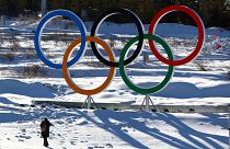 A person walks past the Olympic rings in the Zhangjiakou competition zone ahead of the Beijing 2022 Winter Olympics in Beijing, China 