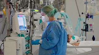 A doctor treats COVID-19 patients connected to ventilators at the hospital of the Ministry of Interior and Administration in Warsaw, Poland, on Wednesday, Jan. 19, 2022.