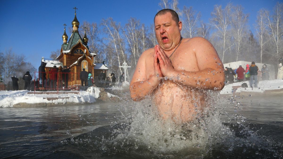 A man bathes in water during a traditional Epiphany celebration as the temperature dropped to -24°C near the Achairsky monastery outside Siberian city of Omsk, Jan. 19, 2021.