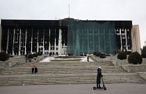 Municipal workers cover the burned city hall for repairs in Almaty.