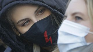 A demonstrator during a protest against alleged police brutality during recent abortion demos, in Warsaw, Poland, Saturday, Feb. 6, 2021