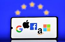 oogle, Apple, Facebook, Amazon and Microsoft displayed on a mobile phone with an EU flag in the background.