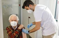 Kurt Switil, left, receives a Pfizer vaccination against COVID in Vienna, April 10, 2021.