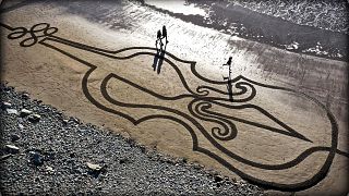 A giant sand artwork in tribute to Ashling Murphy, an Irish schoolteacher who was fatally attacked