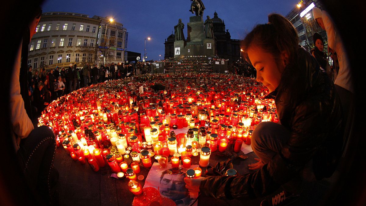 A girl lights a candle in remembrance of Czech statesman Vaclav Havel, who peacefully brought down communism in Czechoslovakia. He died on Dec 18, 2011. He was 75.