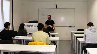 Spanish Professor Andrés Pereira explains his lessons to Afghan refugees at the Camilo José Cela University in Madrid, on January 20, 2022.